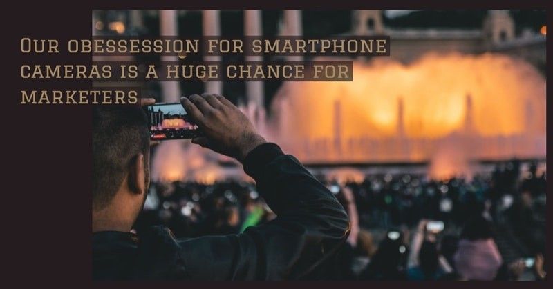 A man films a concert or a theater performance with his smartphone.