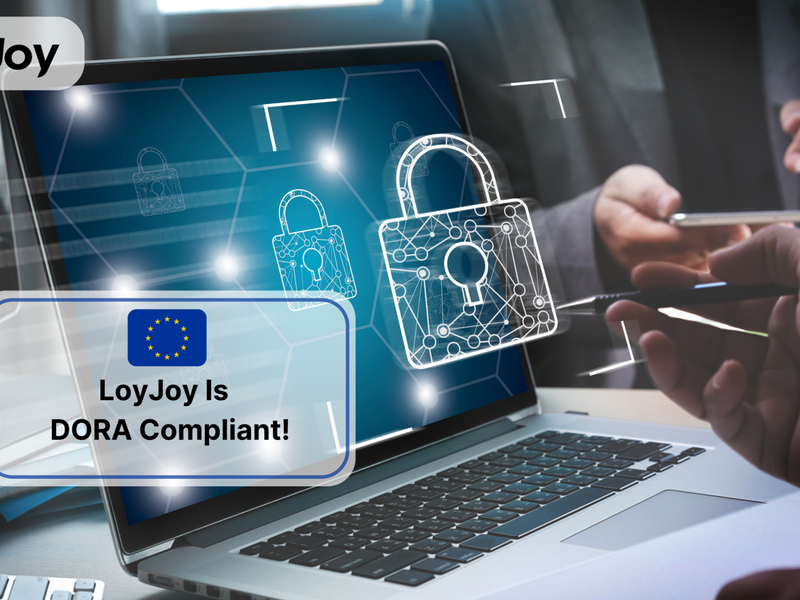 A laptop with a lock to symbolise security. In front of it the inscription: LoyJoy is DORA compliant.