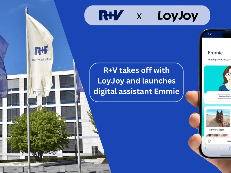 The image shows the launch of the digital assistant Emmie from R+V Insurance, developed with LoyJoy. On the left is the R+V building with fluttering flags, on the right a smartphone with the chatbot Emmie. In the middle it says: 'R+V works together with LoyJoy and launches digital assistant Emmie.'.