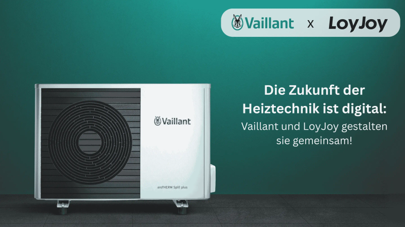 The image shows a modern heat pump from Vaillant against a green background with the text: 'The future of heating technology is digital: Vaillant and LoyJoy are shaping it together!'.